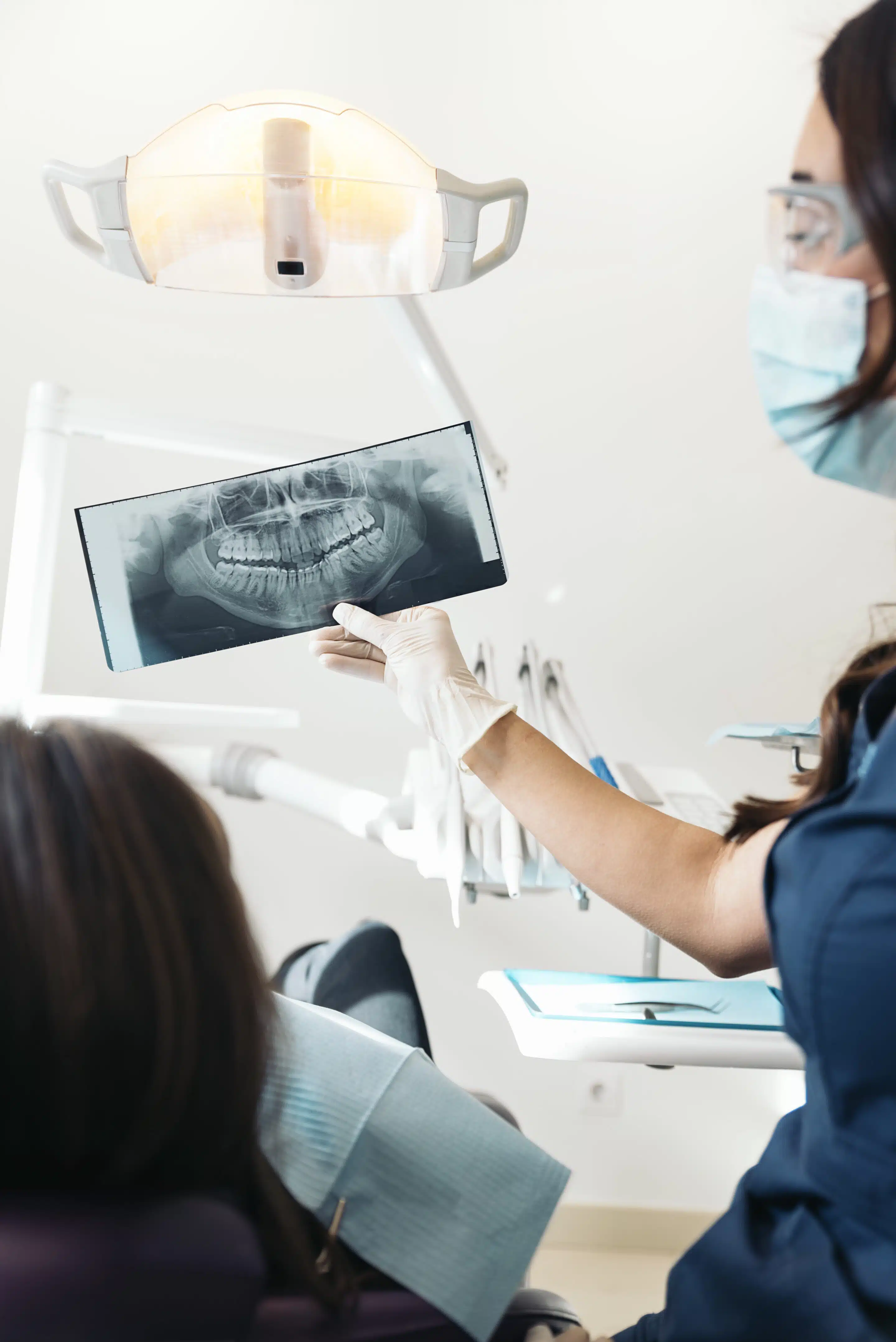 Doctor talking with her patient and teaching a radiograph.